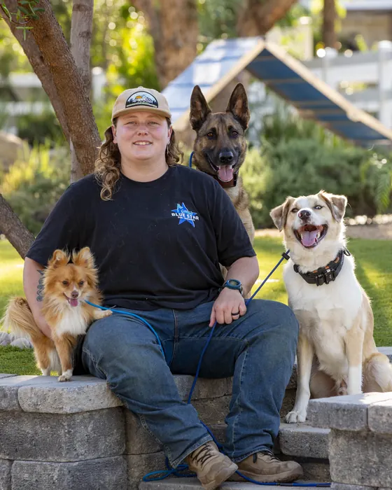 Delaney Feywalker, Dog Trainer at Blue Star Dog Training, with a dog at the ranch
