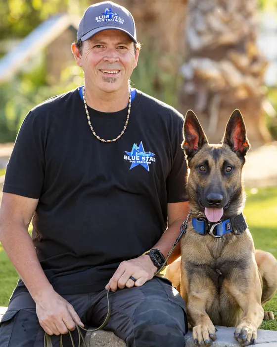 John Barbao, Owner, Trainer at Blue Star Dog Training, with a dog at the ranch