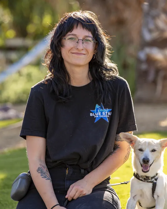 Mekenna Huber, Dog Trainer at Blue Star Dog Training, with a dog at the ranch